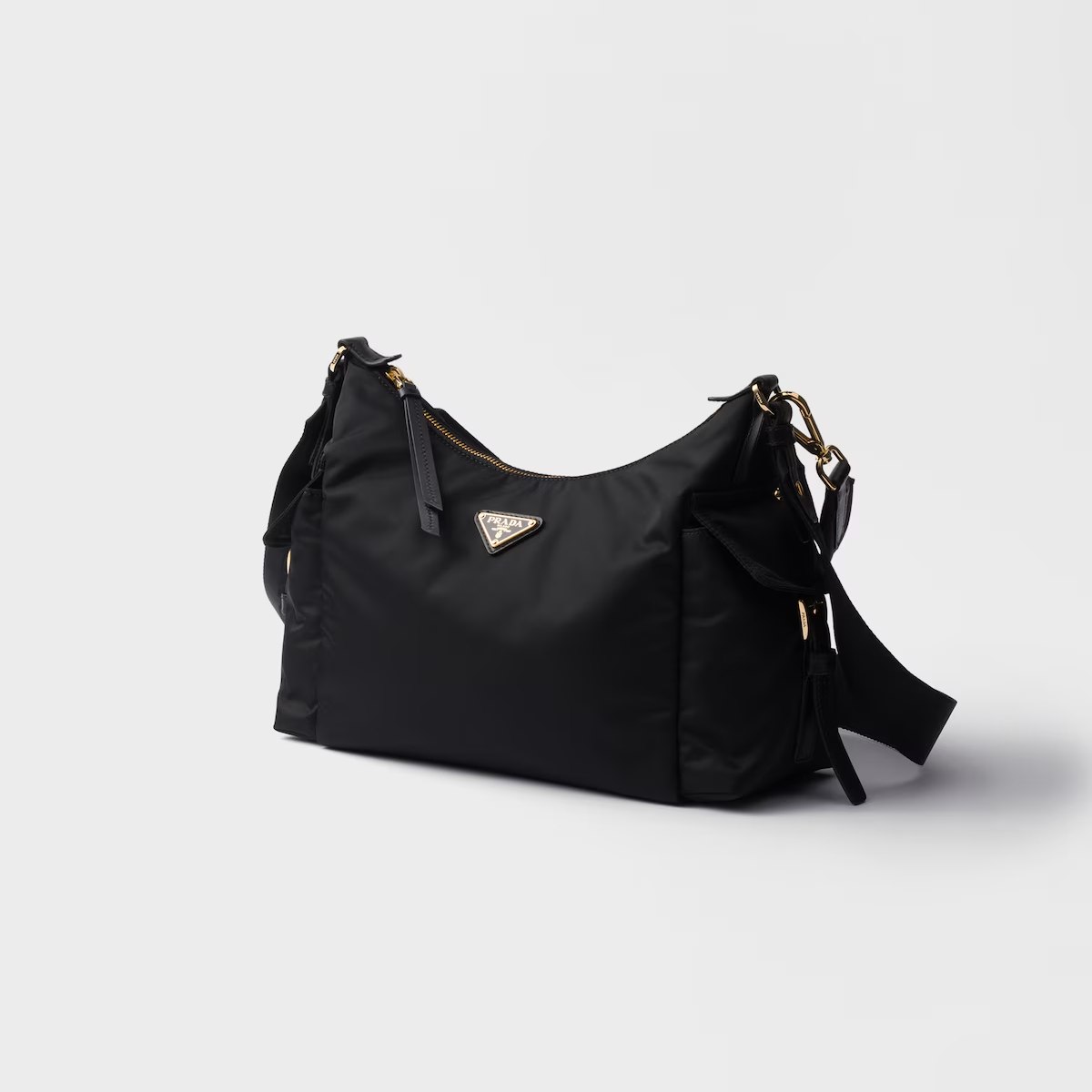 這款半月型的尼龍包，以時髦的版型抓住大眾目光！在細節上，立體的空間，加上左右兩側的口袋，增添其強大的收納性，此外，可手拎及拆卸自如的背帶，更讓其包款擁有更多風格的穿搭。