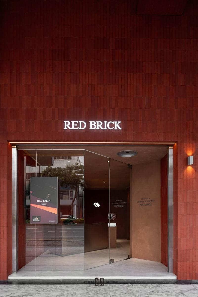 在台南這座文化與美食交織的城市中，擁有 35 年歷史的紅磚布丁 Red Brick，不只是布丁界的代表名店之一，更以其驚艷的空間設計，成為最美麗的街頭風景之一。品牌攜手知名設計團隊知冉設計，跳脫傳統甜點店框架，融合台南傳統紅磚語彙與現代極簡主義，打造出一座充滿對話感的建築作品。大面積的窯燒紅磚立面呼應府城歷史溫度，值得你親自造訪。