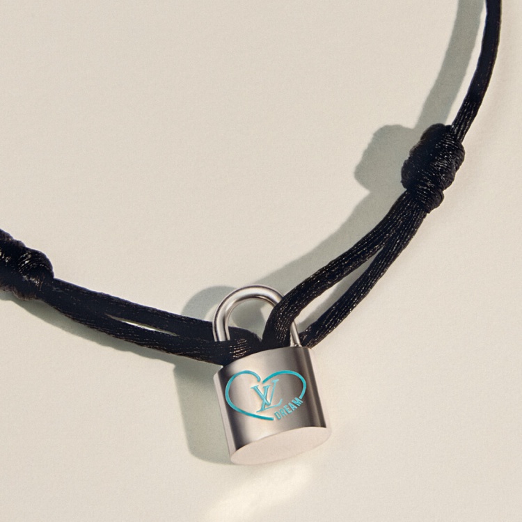 LV 經典的 Silver Lockit 系列，今年找來 K-POP 人氣歌手 Felix 合作，推出全新設計。這款手環以小巧鎖頭鐫刻上藍色心形與「DREAM」字樣，搭配黑、黃、粉、藍等繽紛絲繩，既潮流又富有意義。