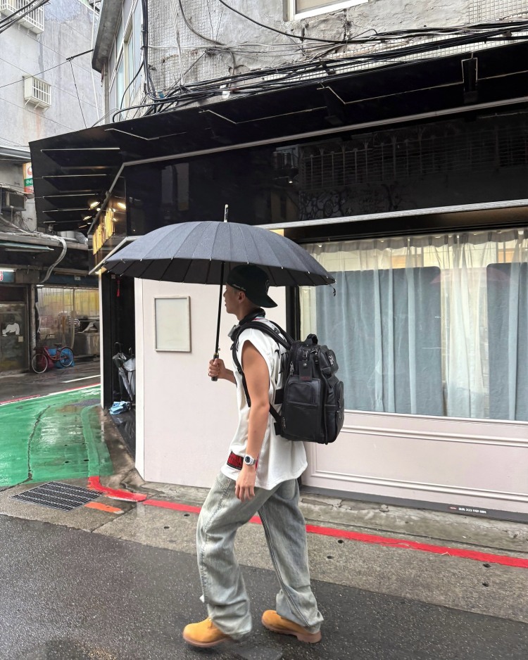 Seventeen Hoshi這套台北街拍造型，以上寬下寬的穿搭邏輯，展現運動混搭機能的時髦感，上身愛迪達的白色無袖籃球背心，以及灰色洗舊感的Entire Studios寬版牛仔褲，其中最吸睛的配件莫過於這款Tumi多口袋後背包，來自經典Alpha系列