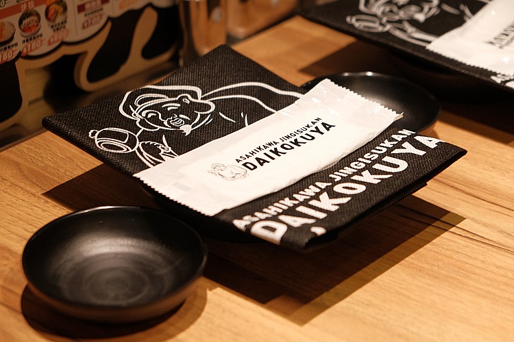 首間海外旗艦店選址於人潮匯聚的中山區，延續旭川本店的精神，以日式氛圍結合現代設計，打造出宛如劇場般的用餐場域。